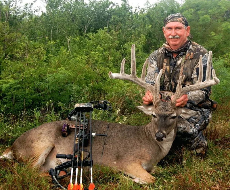 Bowhunter with a large white-tailed buck