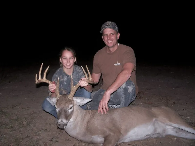Young hunter and guide with a white-tailed buck